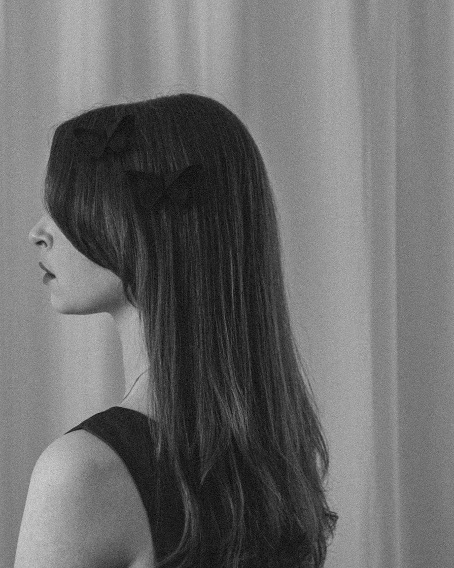 Black and white photo of two small Origami Silk Butterfly Hair Clips on model.