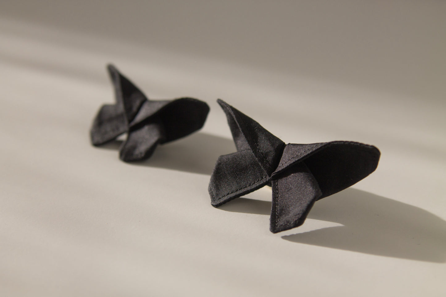Origami Silk Butterfly Hair Clips in Black on white background.