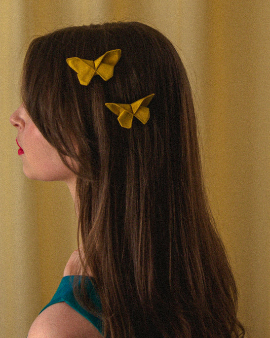 Two Small Origami Silk Butterfly Hair Clips in Golden Yellow on model.