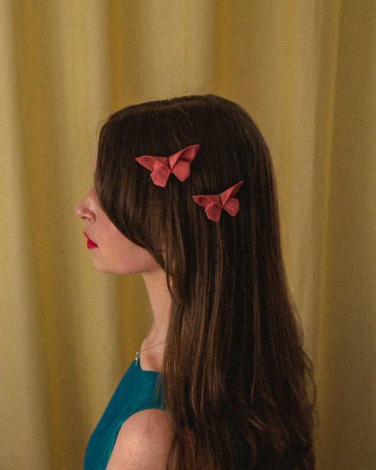 Two Small Origami Silk Butterfly Hair Clips in Light Pink on model.